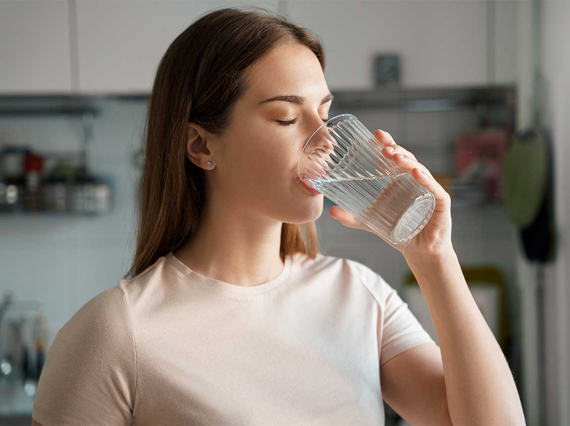 eine Frau mit einem Glas Wasser 